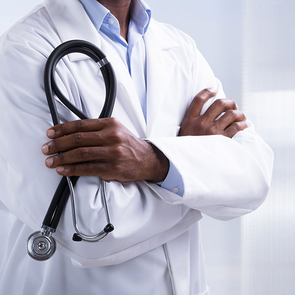 hands of an African American doctor holding a stethoscope