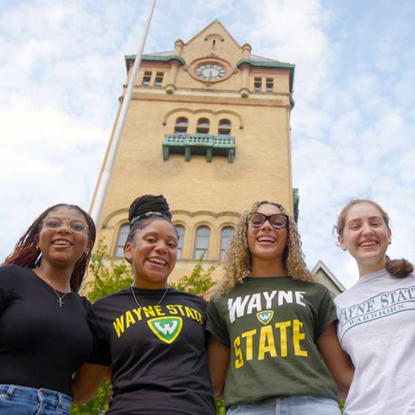 group of female students in front of the Old Main building