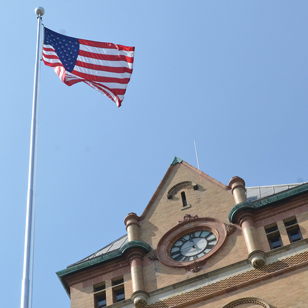 An American flag flying over the Old Main tower