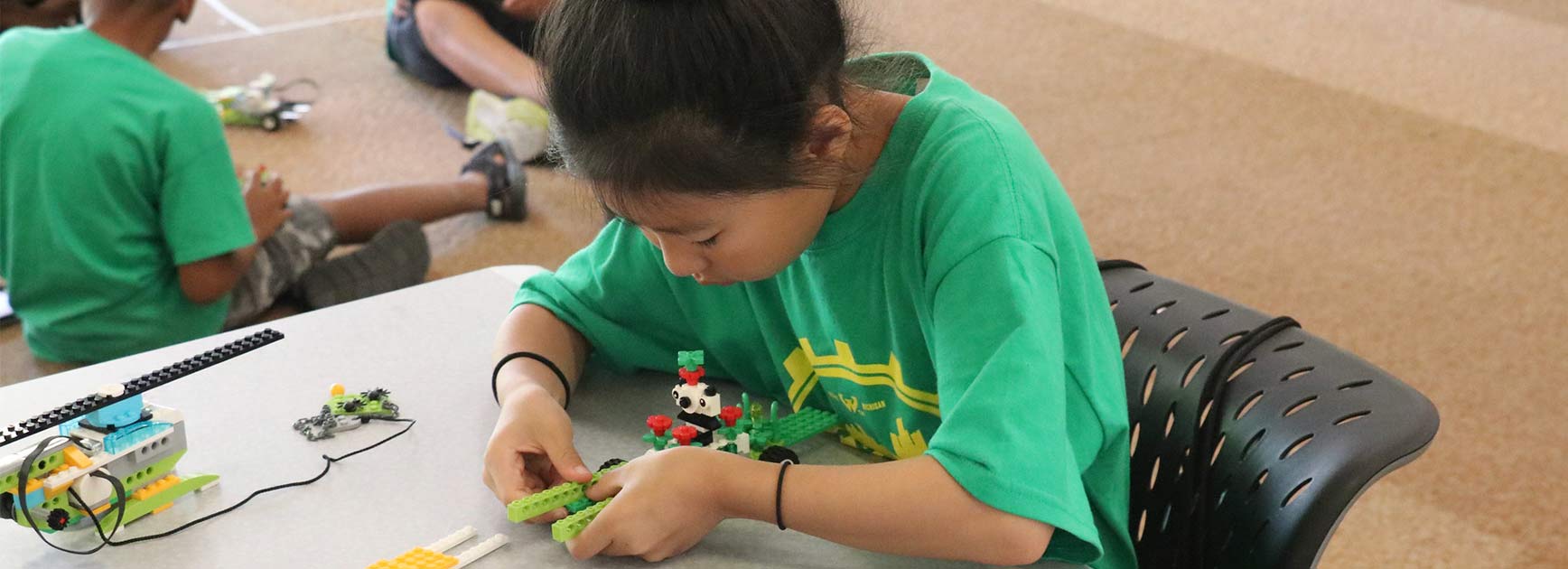 A young person working on a Lego project